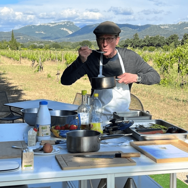 Traveler Bruce from Australia enjoying an outdoor cooking class in Provence with mountains and vineyards in the background