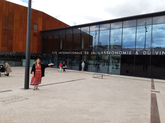 Senior Trip Planner Laura outside the International City of Gastronomy and Wine in Dijon