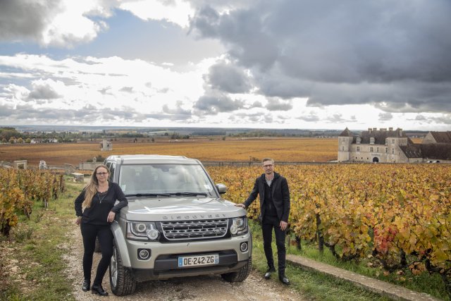 Wine tour guides Eve and Sebastien by their jeep among the Burgundy vineyards