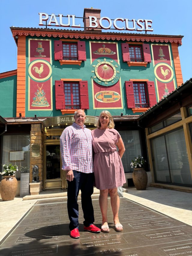 Travelers Julie and Mike outside Paul Bocuse restaurant in Lyon