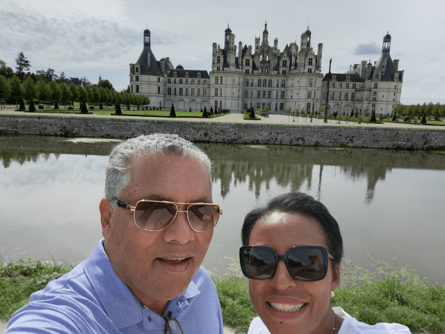 Travelers Eugene and Laura in front of Chambord Castle in the Loire Valley