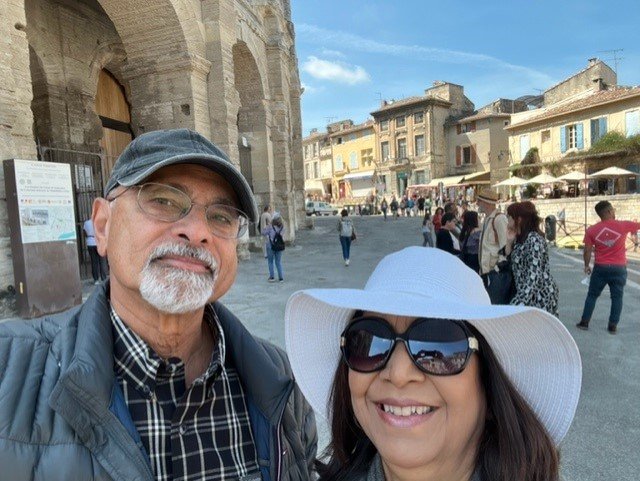 Travelers outside the Roman arena in Arles, Provence