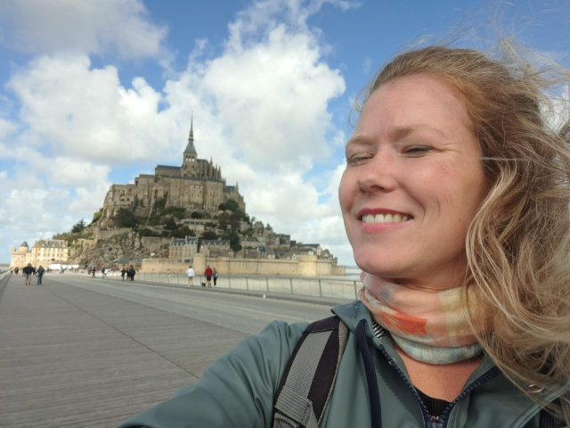 France Just For You trip planner Clelia in front of the islet and abbey of Mont Saint Michel