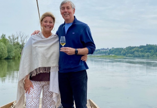 Travelers Lisa and Don enjoying a wine-tasting on a traditional Loire Valley boat